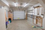 The garage has a few beach toys and space to park a compact vehicle.